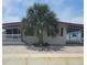 Charming home featuring a well-manicured front yard and a welcoming carport at 138 Maple Dr, Debary, FL 32713