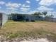 A backyard featuring a covered patio area with an adjacent shed, and secure fencing at 1414 Park Manor Dr, Orlando, FL 32825