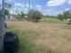Fenced backyard with a mix of grass and dry areas, offering ample space and privacy at 1414 Park Manor Dr, Orlando, FL 32825