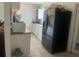 Functional kitchen features stainless steel appliances, white cabinets, and tiled flooring at 1414 Park Manor Dr, Orlando, FL 32825