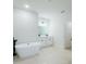Luxurious primary bathroom features a standalone soaking tub and dual vanity with modern finishes at 14957 Sw 63Rd Court Rd, Ocala, FL 34473