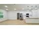 Open-concept kitchen featuring stainless steel appliances, white cabinets, and an island with bar seating at 14957 Sw 63Rd Court Rd, Ocala, FL 34473