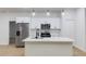 Modern kitchen featuring white cabinets, stainless steel appliances, and a large island with countertop seating at 14957 Sw 63Rd Court Rd, Ocala, FL 34473