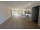 Open-concept living room and kitchen with island, stainless appliances, and sliding glass doors at 14957 Sw 63Rd Court Rd, Ocala, FL 34473