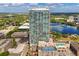 Stunning aerial view of a modern high-rise condo building, surrounded by city, lake and lush greenery at 150 E Robinson St # 2812, Orlando, FL 32801