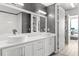 Contemporary bathroom with double vanity, large mirrors, and a walk-in closet at 150 E Robinson St # 2812, Orlando, FL 32801