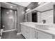 Sleek bathroom featuring double sinks, marble accents, and textured wallpaper at 150 E Robinson St # 2812, Orlando, FL 32801