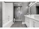 Modern bathroom with a soaking tub, double sink vanity, and textured wallpaper at 150 E Robinson St # 2812, Orlando, FL 32801