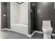 Stylish bathroom featuring a bathtub, toilet, and textured wallpaper at 150 E Robinson St # 2812, Orlando, FL 32801