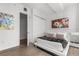 Modern bedroom features sleek white platform bed, closet and colorful artwork at 150 E Robinson St # 2812, Orlando, FL 32801