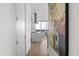 Hallway view showcasing the modern kitchen and dining area with an interesting painting at 150 E Robinson St # 2812, Orlando, FL 32801