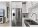 Modern kitchen showcasing stainless steel appliances, white cabinets, and a farmhouse sink at 150 E Robinson St # 2812, Orlando, FL 32801