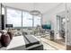 Bedroom featuring large windows with city views, mirrored nightstands and stylish decor at 150 E Robinson St # 2812, Orlando, FL 32801