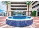 Beautiful blue tiled water fountain in front of The Vue at Lake Lola entrance with a covered drive through and palm trees at 150 E Robinson St # 2812, Orlando, FL 32801
