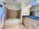 Bathroom with a bathtub, vanity with double sinks, and granite countertops at 150 E Robinson St # 3408, Orlando, FL 32801