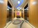 Elevator lobby with three elevators, accent lighting, and decorative floor design at 150 E Robinson St # 3408, Orlando, FL 32801