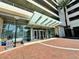 Welcoming condominium entrance featuring a glass canopy, benches and manicured plants at 150 E Robinson St # 3408, Orlando, FL 32801