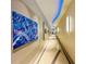 Bright hallway featuring unique blue lighting, decorative flooring, and striking modern art at 150 E Robinson St # 3408, Orlando, FL 32801