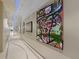Bright hallway featuring unique blue lighting, decorative flooring, and striking modern art at 150 E Robinson St # 3408, Orlando, FL 32801