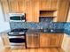 Close-up of kitchen with stainless steel appliances and stylish backsplash at 150 E Robinson St # 3408, Orlando, FL 32801