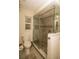 Updated bathroom features a modern glass shower with stone flooring and gray tiled walls at 1529 Glastonberry Rd, Maitland, FL 32751