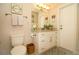Well-lit bathroom with a granite countertop, white cabinets, and decorative accents at 1529 Glastonberry Rd, Maitland, FL 32751