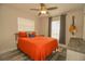 Cozy bedroom with a ceiling fan, an orange bedspread, and a window for natural light at 1529 Glastonberry Rd, Maitland, FL 32751