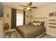 Comfortable bedroom featuring neutral colors, a ceiling fan, and decorative wall art at 1529 Glastonberry Rd, Maitland, FL 32751