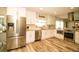 Modern kitchen featuring stainless steel appliances, white cabinetry, and wood-look floors at 1529 Glastonberry Rd, Maitland, FL 32751