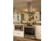 Stainless steel range and microwave in modern kitchen with stone countertops at 1529 Glastonberry Rd, Maitland, FL 32751