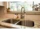 Kitchen sink with granite countertops, stainless steel faucet and subway tile backsplash at 1529 Glastonberry Rd, Maitland, FL 32751