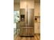 Close-up of a stainless steel refrigerator with water dispenser, complementing the cabinetry and design at 1529 Glastonberry Rd, Maitland, FL 32751