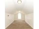 Bright attic space with neutral carpet, white walls, and natural light from an arched window at 1645 Boulder Creek Ct, Apopka, FL 32712