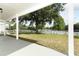 Covered patio with a view of the yard, a white fence and a peaceful lake at 1645 Boulder Creek Ct, Apopka, FL 32712