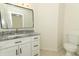 Bathroom featuring a modern vanity with granite countertop and black hardware, plus a toilet at 1645 Boulder Creek Ct, Apopka, FL 32712