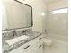 Stylish bathroom with a granite vanity, shower over tub, and bright lighting at 1645 Boulder Creek Ct, Apopka, FL 32712