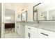 Dual sink bathroom with granite countertops, black hardware, and bedroom view at 1645 Boulder Creek Ct, Apopka, FL 32712