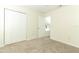 Bedroom with neutral carpet, closet, ceiling fan and view to another room at 1645 Boulder Creek Ct, Apopka, FL 32712