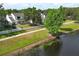 Charming two-story home with a white picket fence, mature trees, and lake views at 1645 Boulder Creek Ct, Apopka, FL 32712