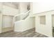 Bright foyer featuring wood-look floors, high ceilings and a staircase leading upstairs at 1645 Boulder Creek Ct, Apopka, FL 32712