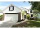 Inviting two-story home featuring a two car garage, manicured lawn and a walkway leading to the front door at 1645 Boulder Creek Ct, Apopka, FL 32712