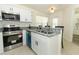 Well-equipped kitchen boasts stainless steel appliances, granite countertops, and a breakfast bar at 1645 Boulder Creek Ct, Apopka, FL 32712