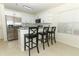 Modern kitchen with stainless steel appliances, granite countertops, and seating at the breakfast bar at 1645 Boulder Creek Ct, Apopka, FL 32712