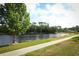 Scenic lake view with mature trees and a walking path on a sunny day at 1645 Boulder Creek Ct, Apopka, FL 32712