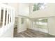 Bright living room with wood-look floors, lots of natural light and a staircase leading upstairs at 1645 Boulder Creek Ct, Apopka, FL 32712