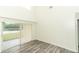 Bright living room featuring wood-look floors and a sliding glass door leading to the backyard at 1645 Boulder Creek Ct, Apopka, FL 32712