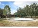 Playground featuring a swing set with benches, set in a well-maintained grassy area at 1645 Boulder Creek Ct, Apopka, FL 32712