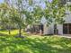 Lush backyard with mature trees and a screened-in patio perfect for outdoor relaxation and enjoying nature at 1772 Garden Sage Dr, Oviedo, FL 32765