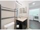 Cozy bathroom featuring a dark vanity with a light countertop and a convenient laundry room nearby at 1772 Garden Sage Dr, Oviedo, FL 32765