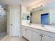 This bright bathroom features a double vanity, tiled shower, and separate toilet area at 1772 Garden Sage Dr, Oviedo, FL 32765